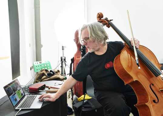 Photo: Chris Freeman Peter Nagle portrait with cello and laptop